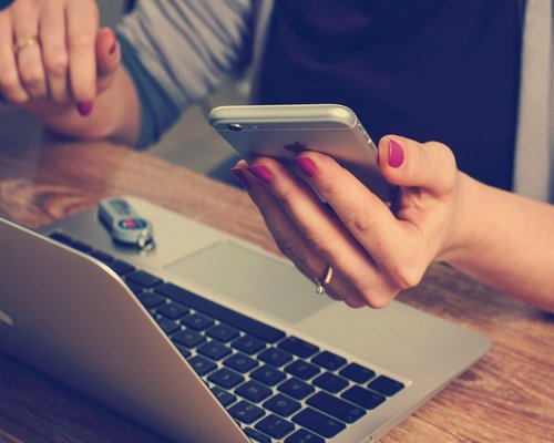 Phone and notebook on a well lit desk