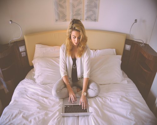 Person working on a laptop at home in Italy